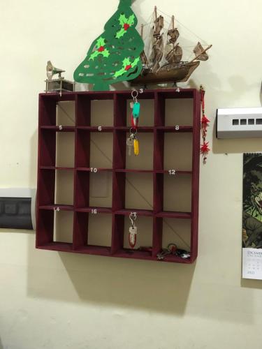 a shelf with a christmas tree on top of it at Dama HostelBB in Naples