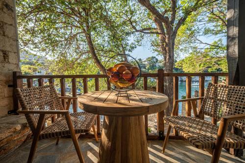 a wooden table with a vase on top of it at Cleopatra's Miramare in Damouchari