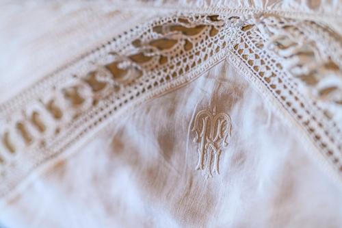 a close up of the embroidery on a wedding dress at Cleopatra's Miramare in Damouchari