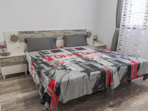 a bedroom with a bed with a black and red blanket at SUNSET RUBY ,1 Bedroom, SWIMMING POOL in Caleta De Fuste