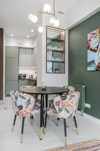 a dining room with a table and chairs at Old City Apartments in Lviv