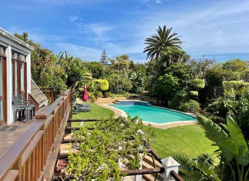 a backyard with a swimming pool and a wooden fence at Aberdour Guesthouse in Port Elizabeth
