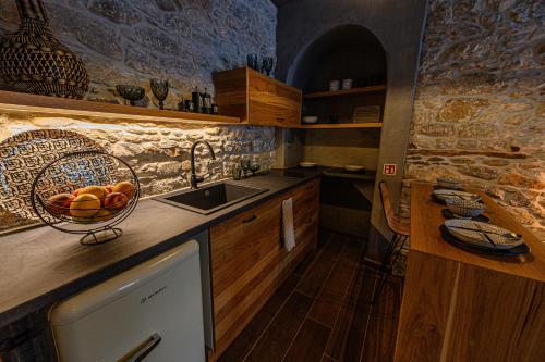 a kitchen with a bowl of fruit on the counter at Cleopatra's Miramare in Damouchari