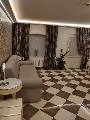 a living room with a couch and a checkered floor at Ca' Marinella in Venice