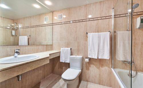 a bathroom with a toilet and a sink and a shower at Globales Cala'n Bosch in Cala en Bosc