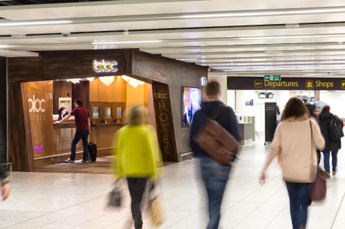 a group of people walking in a shopping mall at Bloc Hotel London Gatwick Airport in Horley
