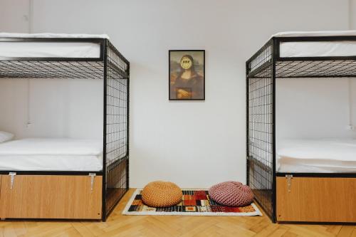 two bunk beds in a room with a wall at Party Hostel Zzz in Ljubljana