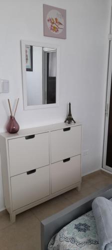 a white dresser with a mirror on top of it at Residencial Palmas De Gurabo in Santiago de los Caballeros