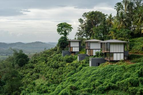 a row of tree houses on a hillside at Glenross Living - A Collection of 7 Private Pool Villas and 3 Colonial Suites in Kalutara