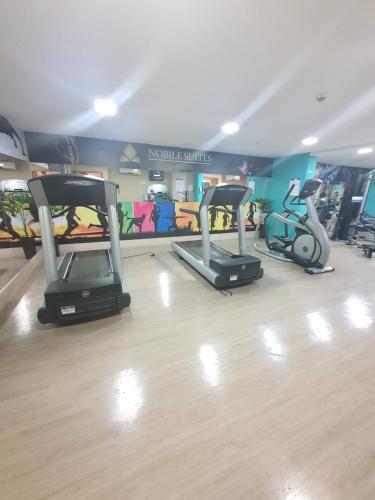 a gym with three exercise bikes in a room at Flat Nobile Suítes Monumental By Rei dos Flats, in Brasilia