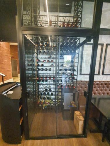 a room with a wall of wine bottles at Flat Nobile Suítes Monumental By Rei dos Flats, in Brasilia