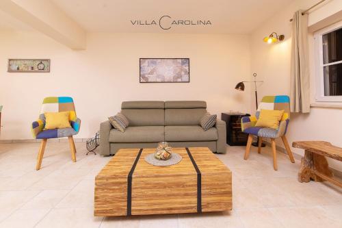 a living room with a couch and two chairs at Villa Carolina in Izola