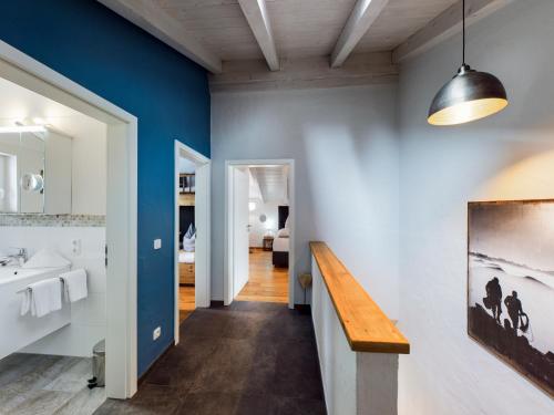 a bathroom with blue walls and a sink at Hoamat 17 in Garmisch-Partenkirchen