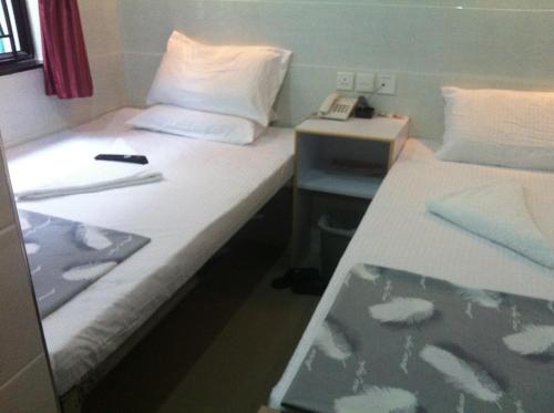 Postel nebo postele na pokoji v ubytování New Cosmos Hotel