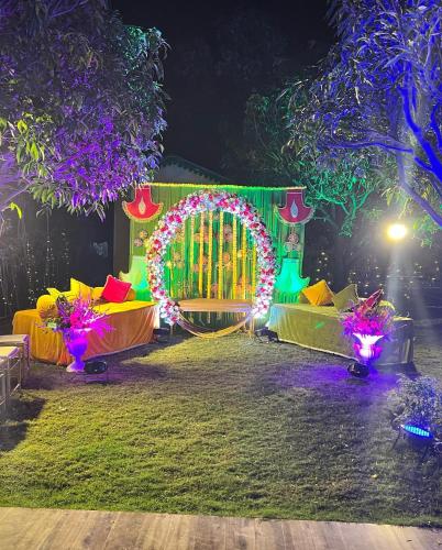 a park with an arch and lights at night at Seven Corbett in Rāmnagar