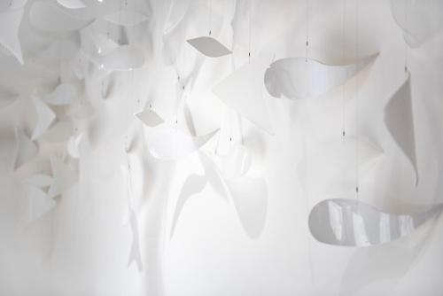 a white wall with a bunch of white objects at Hotel & Restaurant Rössli in Stansstad