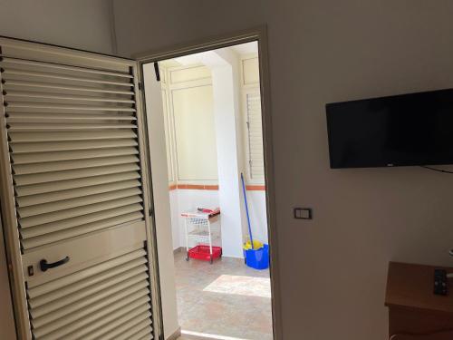 a room with a door with a television on a wall at A&d in Carrao