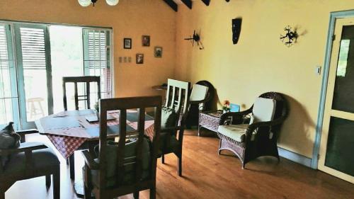 
a living room filled with furniture and a table at Villa Florie Guest House - Economic Rooms in Sosúa
