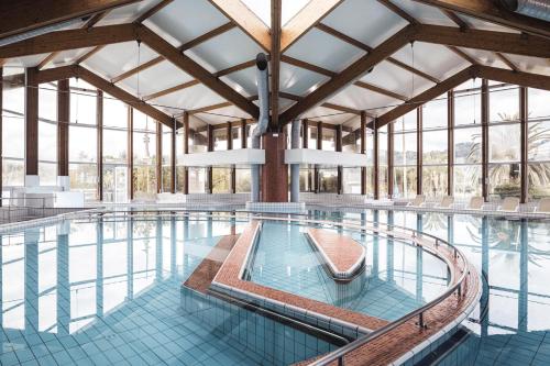 a large swimming pool with a large ceiling at Hôtel Serge Blanco - Relais Thalasso & Spa in Hendaye