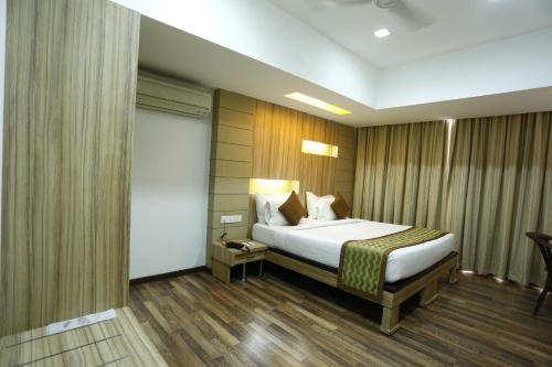 a hotel room with a bed in a room at Hotel City Centre Residency in Bengaluru