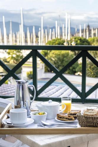 a breakfast table with a view of the city at Hôtel Serge Blanco - Relais Thalasso & Spa in Hendaye