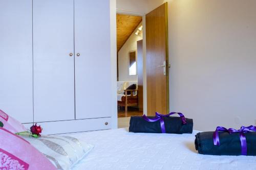a bedroom with a bed with two bags on it at Apartment Matic in Dubrovnik