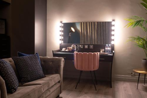 a living room with a couch and a table with a mirror at 62 Castle Street Hotel in Liverpool