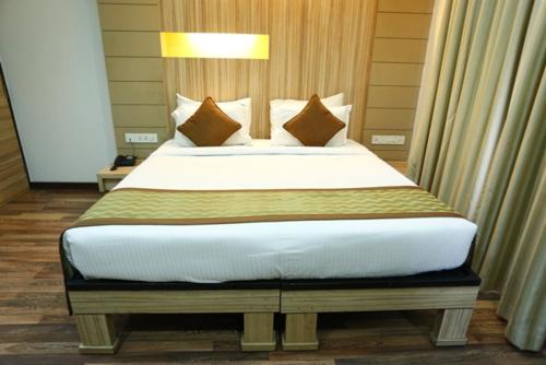 a bedroom with a large bed with a white bedspread at Hotel City Centre Residency in Bengaluru