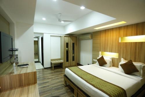 a bedroom with a large bed in a room at Hotel City Centre Residency in Bengaluru