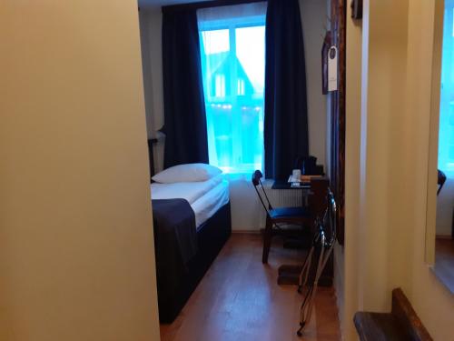 a small bedroom with a bed and a window at Hotel Viking in Hafnarfjördur