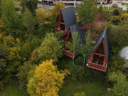 an overhead view of two houses in the trees at Paradiso Mestia in Mestia