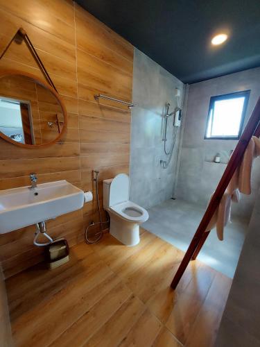 a bathroom with a sink and a toilet and a shower at Palms Retreat in Fulhadhoo