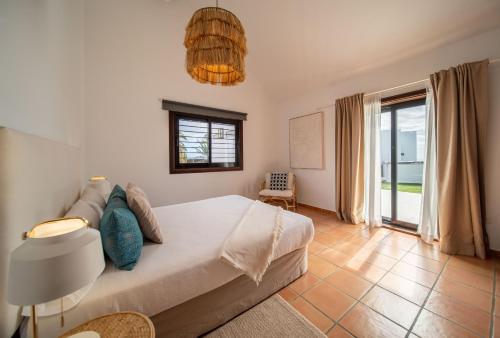 a bedroom with a large bed and a window at VillaMare in Puerto del Carmen