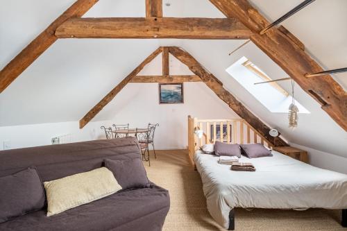 a living room with a bed and a couch at Le Grand Cancalais in Cancale