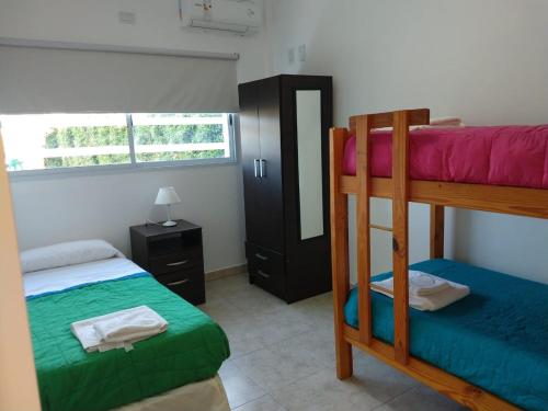 a bedroom with two bunk beds and a mirror at Apart del YERUA in Puerto Yeruá