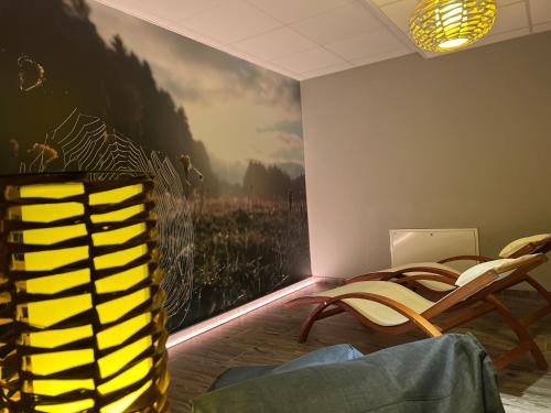 a room with chairs and a painting on the wall at Resort Pasecna in Přední Výtoň