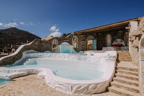 a large bath tub sitting on top of a building at Calilo in Manganari
