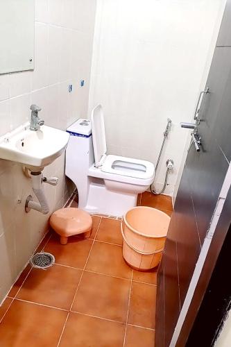 a bathroom with a toilet and a sink at Hotel Thakur Shri in Bhopal