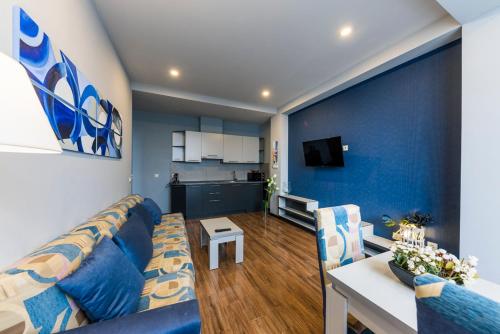 a living room with a couch and a table and a kitchen at Sani Apart Hotel in Tbilisi City