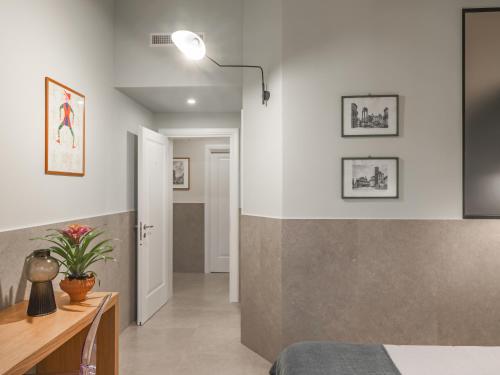 a bedroom with a bed and a desk and a lamp at Maison boutique Matteotti in Matera