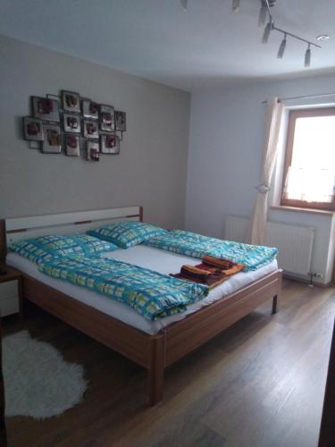 a bedroom with a bed and a window at Appartement Schmittenblick in Zell am See