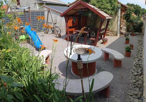 a garden with a fountain and a small playground at BORINA VENDÉGHÁZ in Sátoraljaújhely