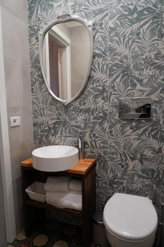 a bathroom with a sink and a mirror at DS Apartment in Catania