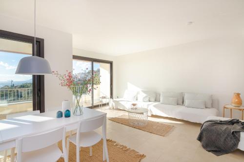 a white living room with a bed and a table at Luxurius Penthouse with Large Terrace and Spa in Marbella