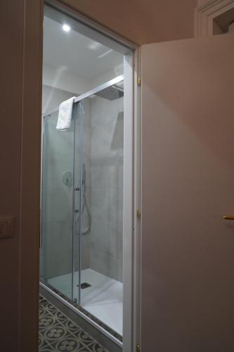 a shower with a glass door in a bathroom at DS Apartment in Catania