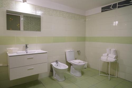 a bathroom with a toilet and a sink at DS Apartment in Catania