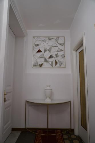 a white room with a table and a picture on the wall at DS Apartment in Catania