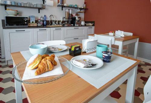 a kitchen with a table with croissants on it at b&b Casa Livia in Pordenone