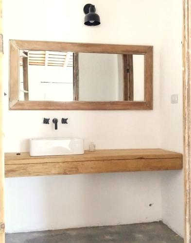 a bathroom with a sink and a mirror at LA FLORIDA - CASA PUEBLO in San Antonio de Areco