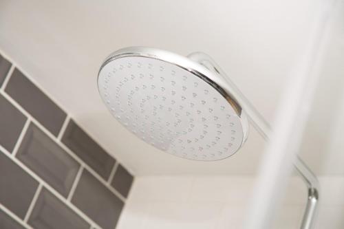 a shower with a shower head in a bathroom at Willowbeck Lodge Boutique Hotel in Carlisle